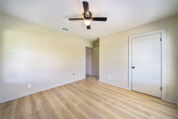 a view of room with window and ceiling fan