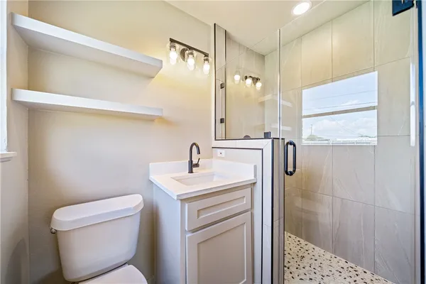 a bathroom with a toilet sink and shower