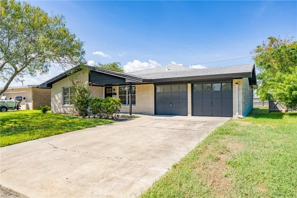 a front view of house with yard and green space