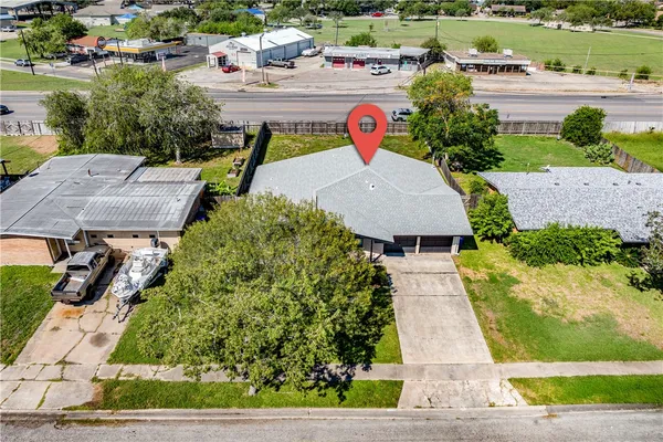 an aerial view of a house with garden space and street view