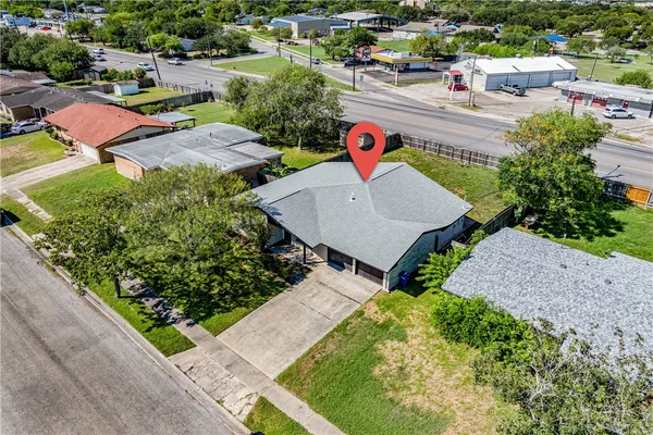 an aerial view of a house with a garden and lake view