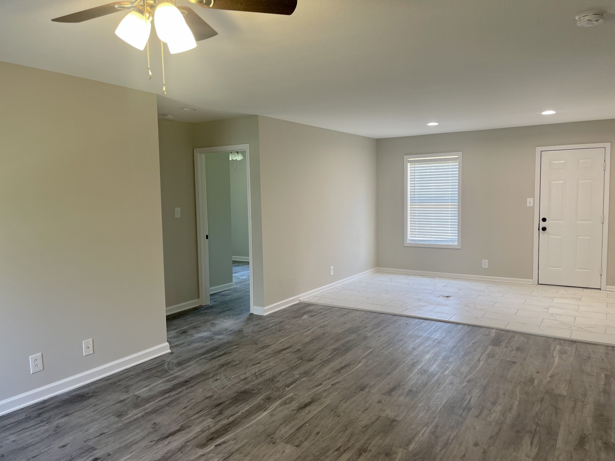 1845 Hugh Hunter Road Oak Grove, KY 42262 - Photo 3 of 6 an empty room with wooden floor fan and windows