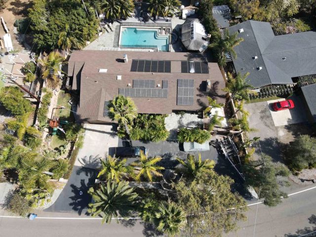 a bathroom with a granite countertop sink a large mirror and shower