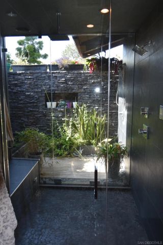 a kitchen with stainless steel appliances granite countertop a sink a stove and a wooden floors