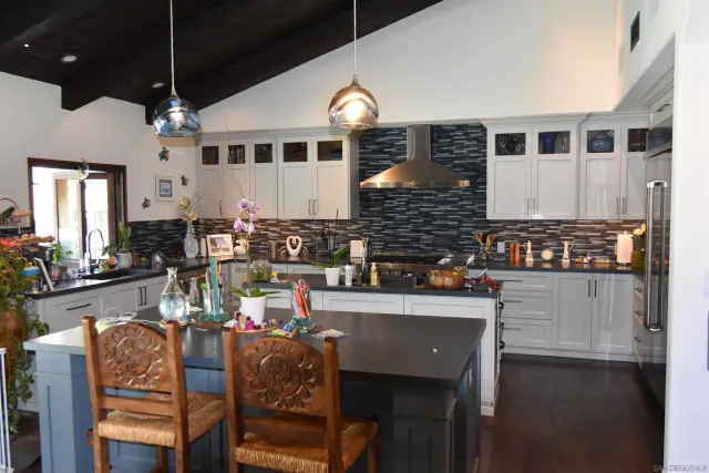 a kitchen with stainless steel appliances granite countertop a stove and a sink