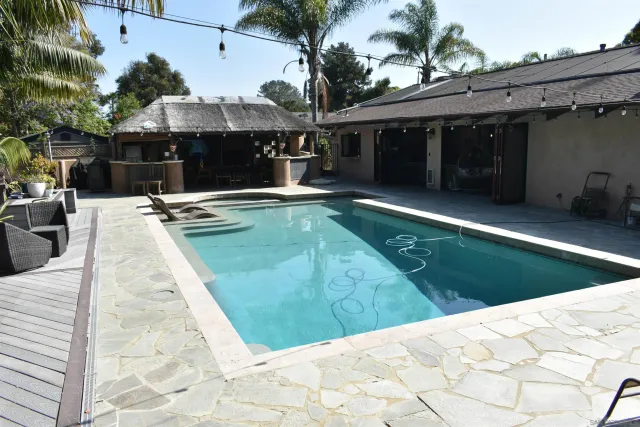 a view of a house with backyard porch and sitting area