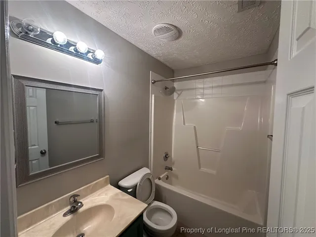 a bathroom with a sink toilet a mirror and shower