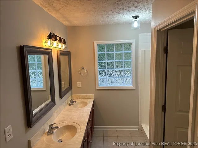 a bathroom with a sink toilet and mirror