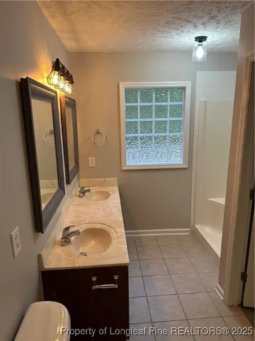 a bathroom with a glass shower door