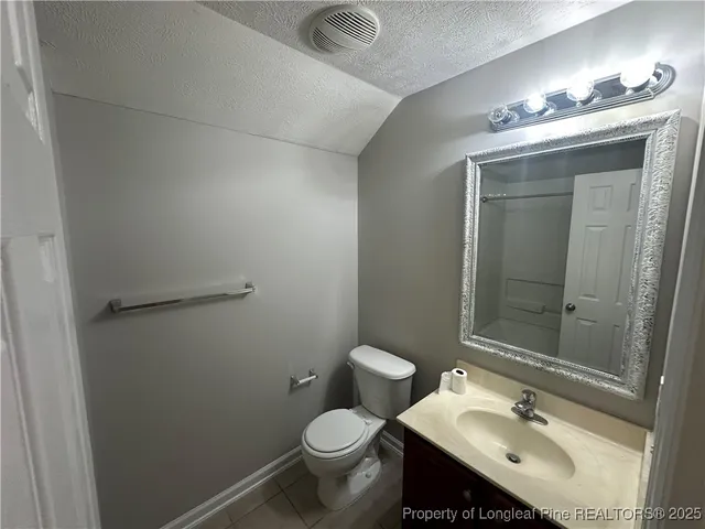 an empty room with a chandelier fan and a chandelier fan