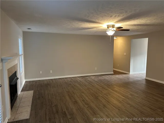 wooden floor in an empty room with a fireplace