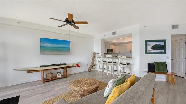a kitchen with granite countertop a sink a stove cabinets and a counter top space