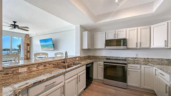 a bathroom with a granite countertop sink toilet a shower and a mirror