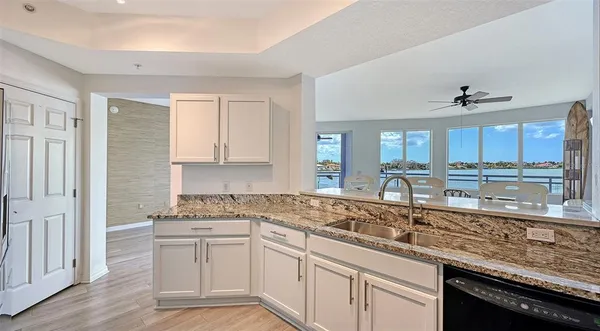 a view of a bedroom with a bed and wooden floor