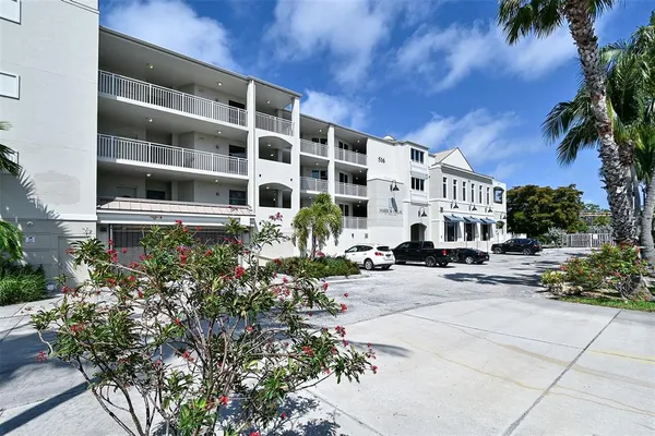 a living room with furniture a flat screen tv and wooden floor