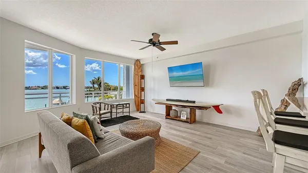 a living room with furniture and a wooden floor