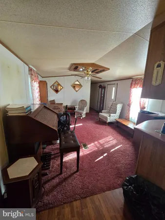 a living room with furniture and a clock