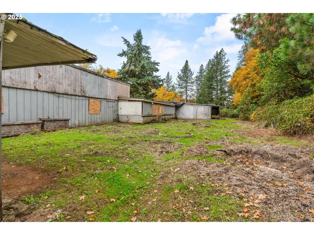 a view of a house with a yard and sitting area