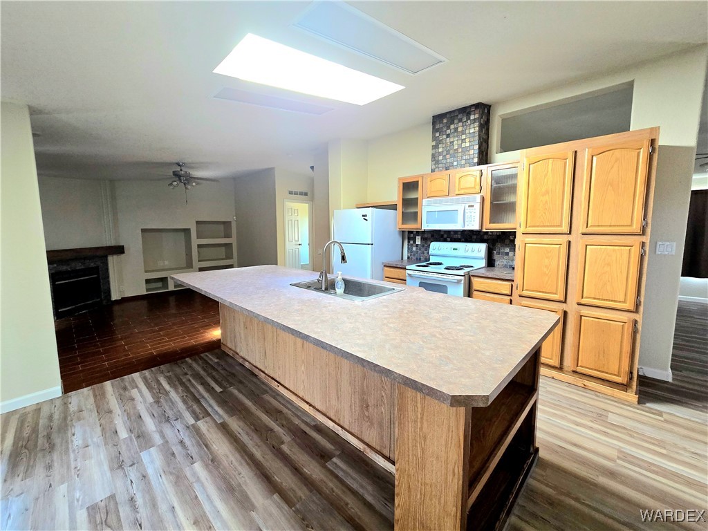 4149 Carrizo Road Golden Valley, AZ 86413 - Photo 17 of 47 a kitchen with kitchen island a counter top space a sink a refrigerator and a stove