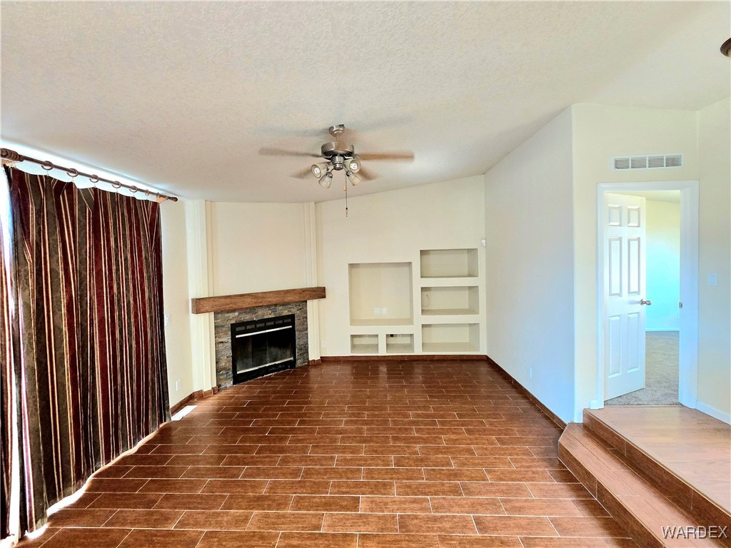 4149 Carrizo Road Golden Valley, AZ 86413 - Photo 25 of 47 a view of an empty room with a fireplace and a window
