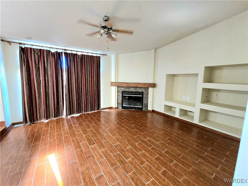 4149 Carrizo Road Golden Valley, AZ 86413 - Photo 26 of 47 a view of an empty room with a fireplace and a window