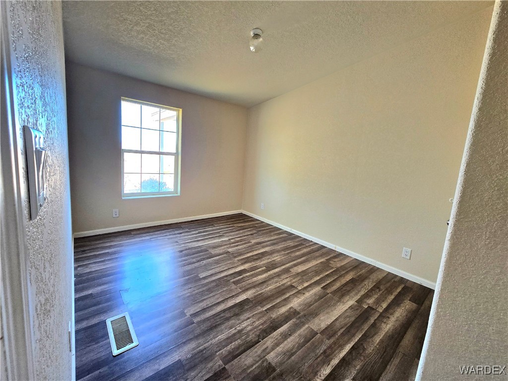 4149 Carrizo Road Golden Valley, AZ 86413 - Photo 28 of 47 an empty room with wooden floor and windows