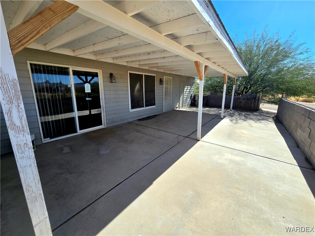 4149 Carrizo Road Golden Valley, AZ 86413 - Photo 32 of 47 a view of a house with backyard and porch