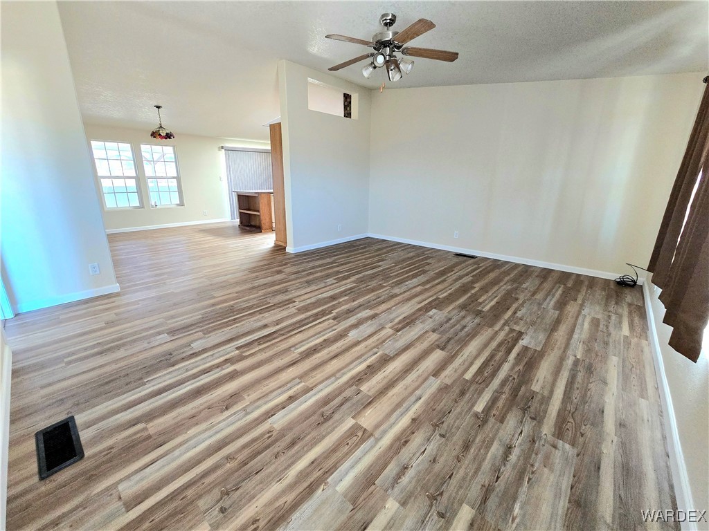 4149 Carrizo Road Golden Valley, AZ 86413 - Photo 4 of 47 a view of empty room with wooden floor and fan