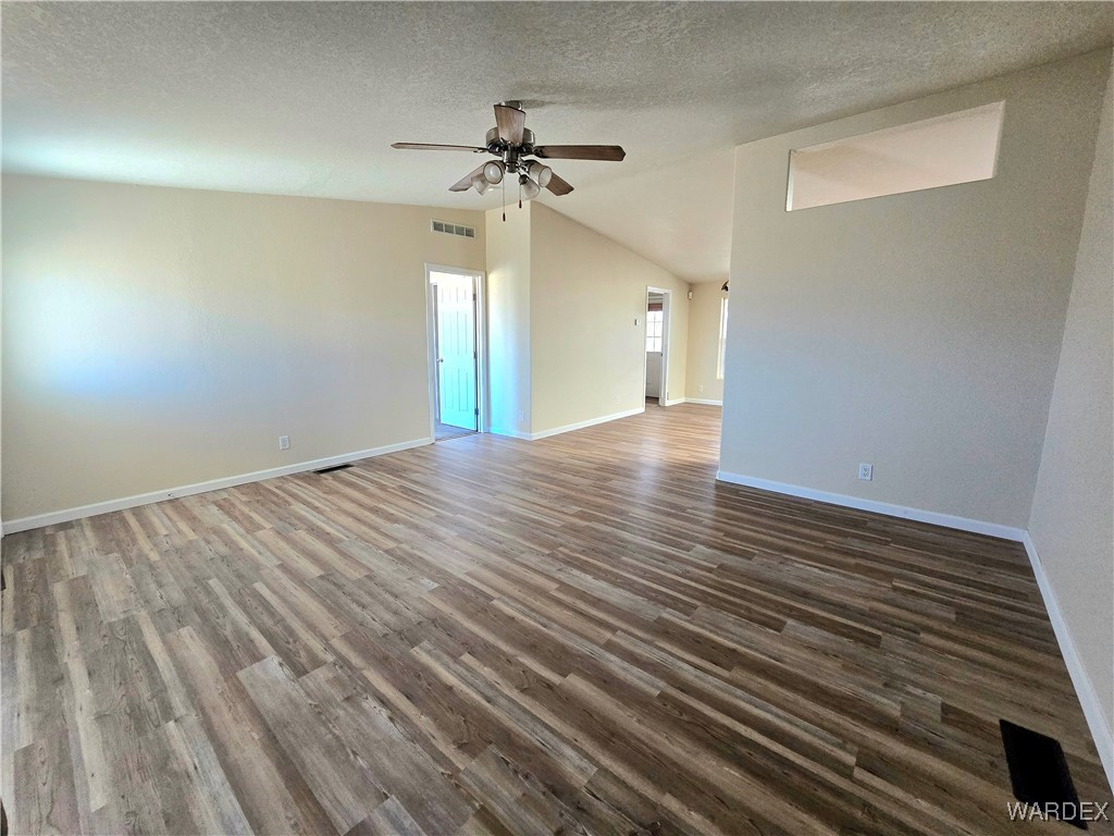 4149 Carrizo Road Golden Valley, AZ 86413 - Photo 5 of 47 wooden floor in an empty room with a window
