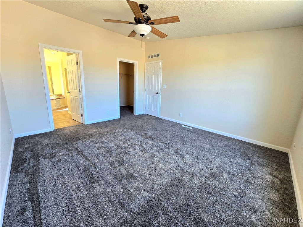 4149 Carrizo Road Golden Valley, AZ 86413 - Photo 7 of 47 a view of a big room with closet and ceiling fan