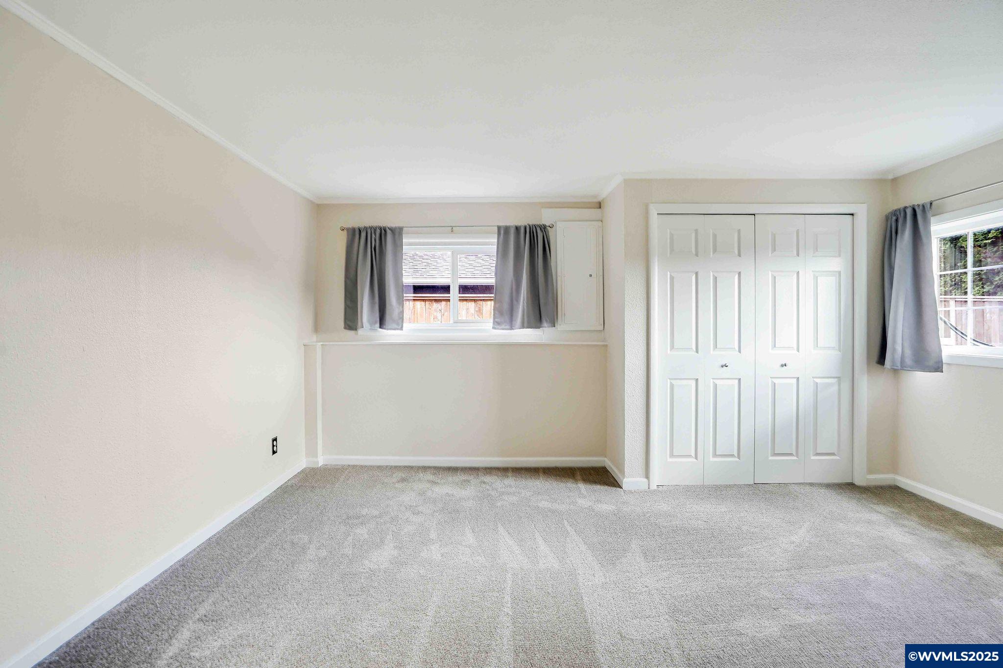 4843 Hazelgreen Road Northeast Salem, OR 97305 - Photo 28 of 48 an empty room with windows and closet