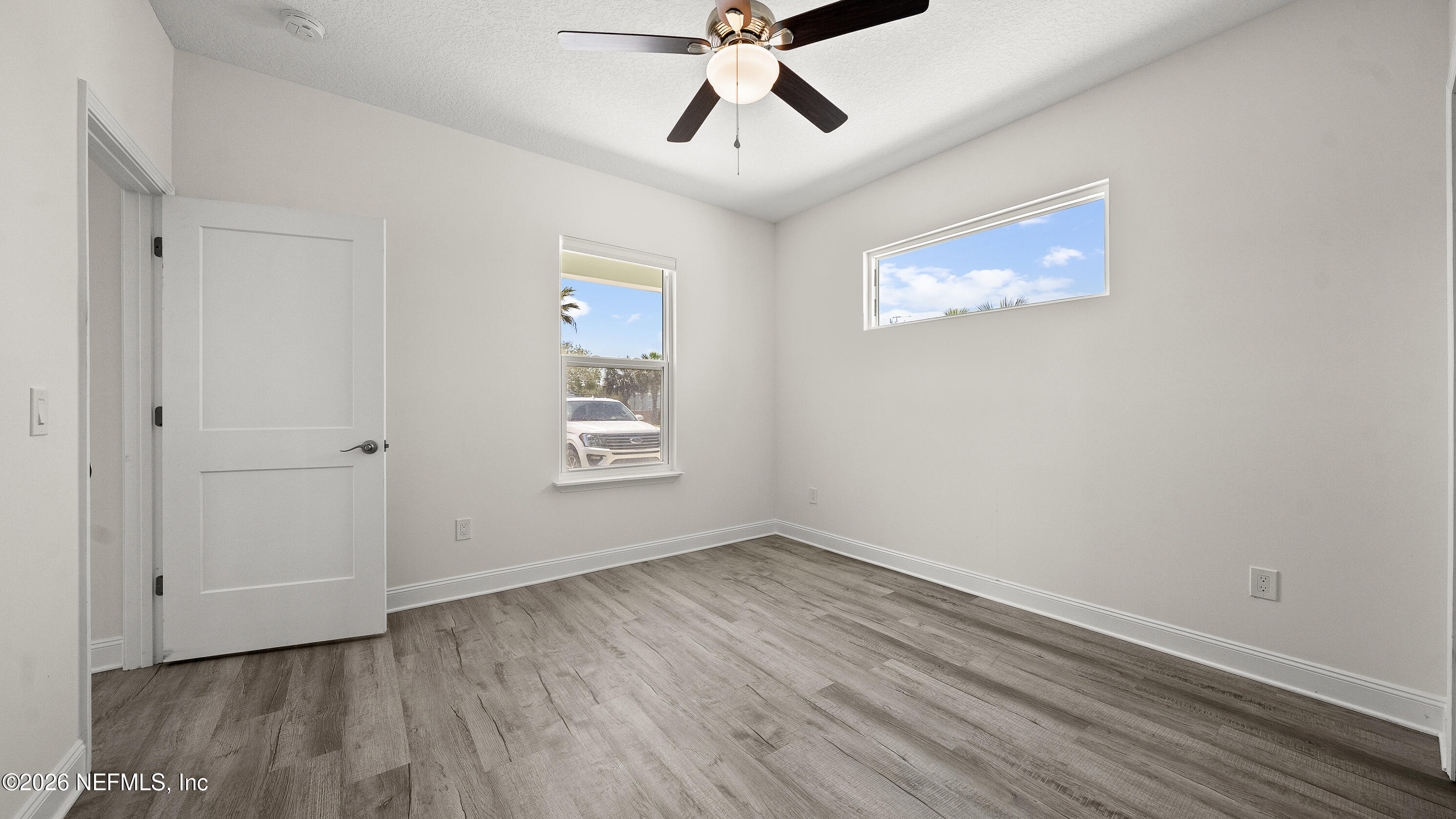 80 Seaside Capers Road St. Augustine, FL 32084 - Photo 12 of 44 wooden floor in an empty room with a window