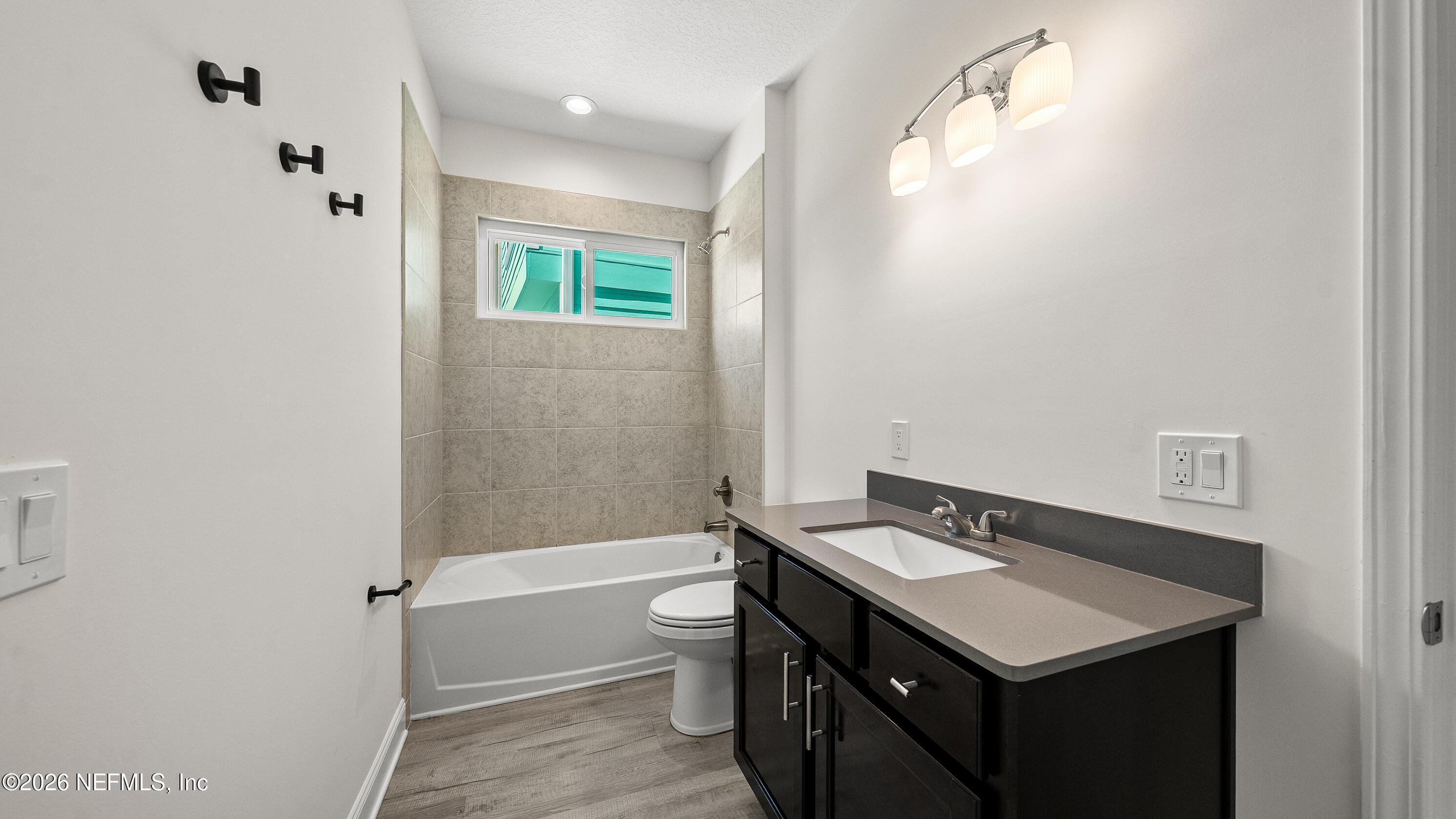 80 Seaside Capers Road St. Augustine, FL 32084 - Photo 15 of 44 a bathroom with a sink a toilet and shower