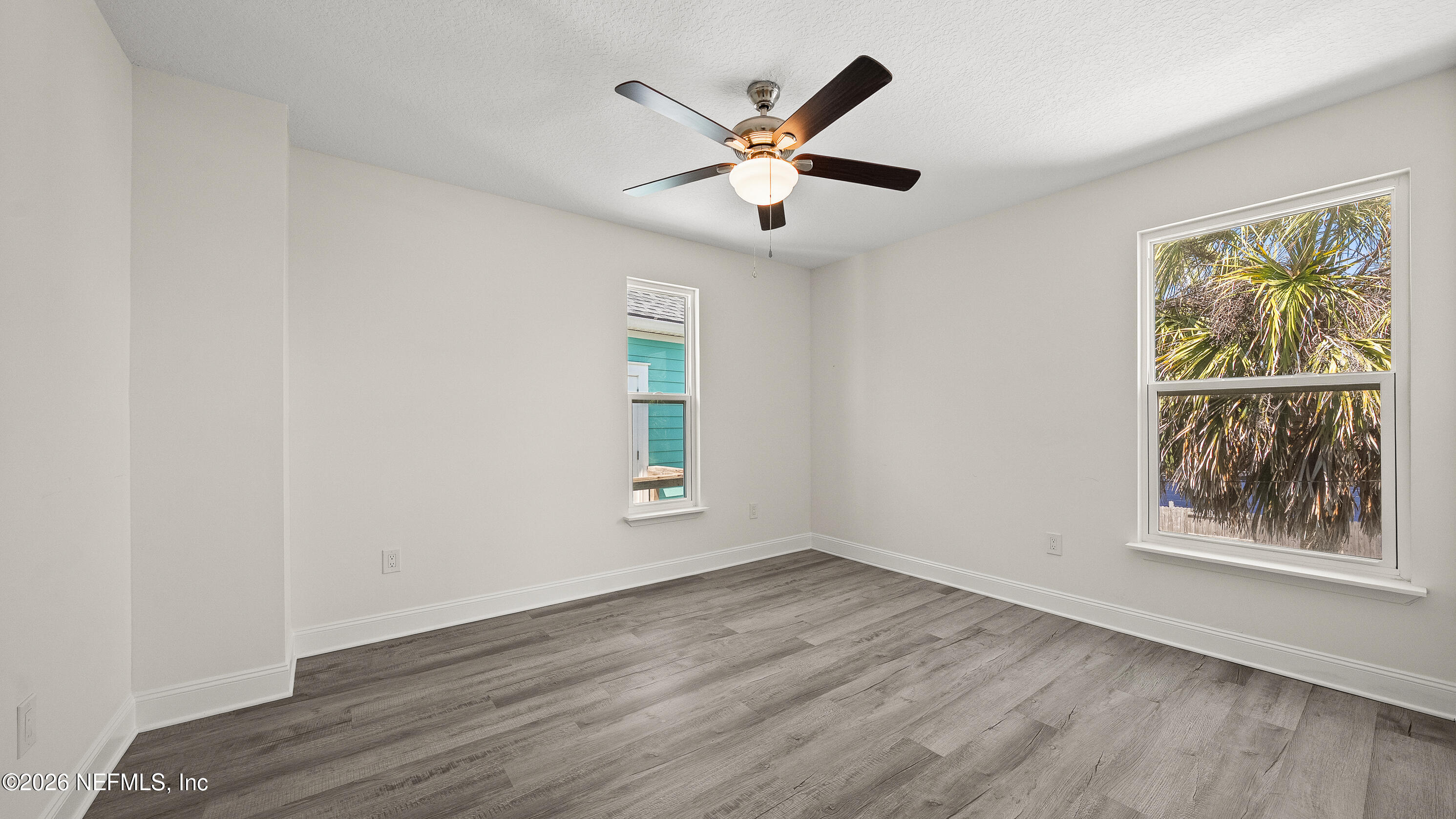 80 Seaside Capers Road St. Augustine, FL 32084 - Photo 25 of 44 a view of an empty room with wooden floor and a window