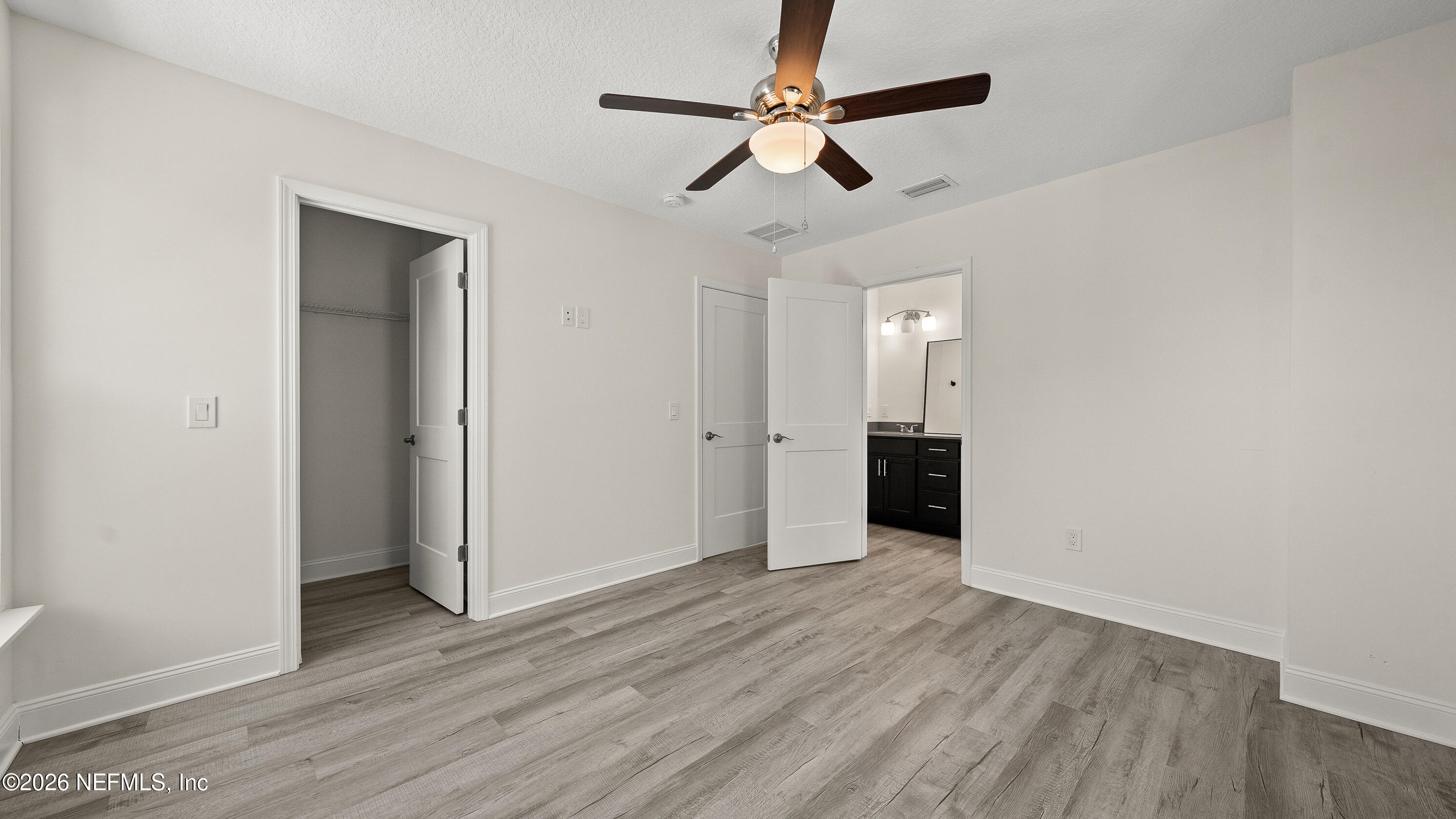 80 Seaside Capers Road St. Augustine, FL 32084 - Photo 26 of 44 wooden floor in an empty room with a window