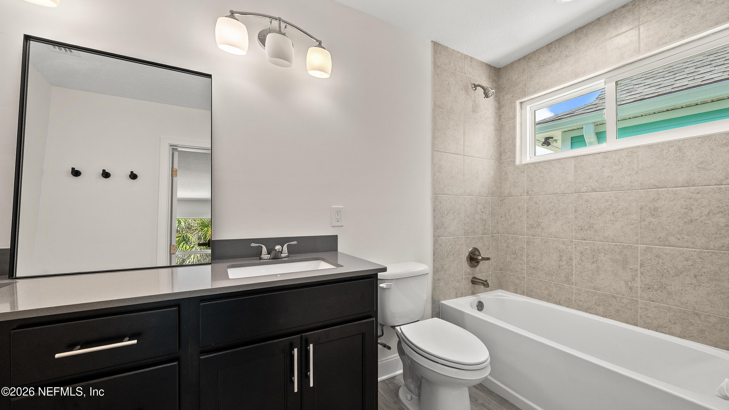 80 Seaside Capers Road St. Augustine, FL 32084 - Photo 27 of 44 a bathroom with a sink a toilet a tub and shower