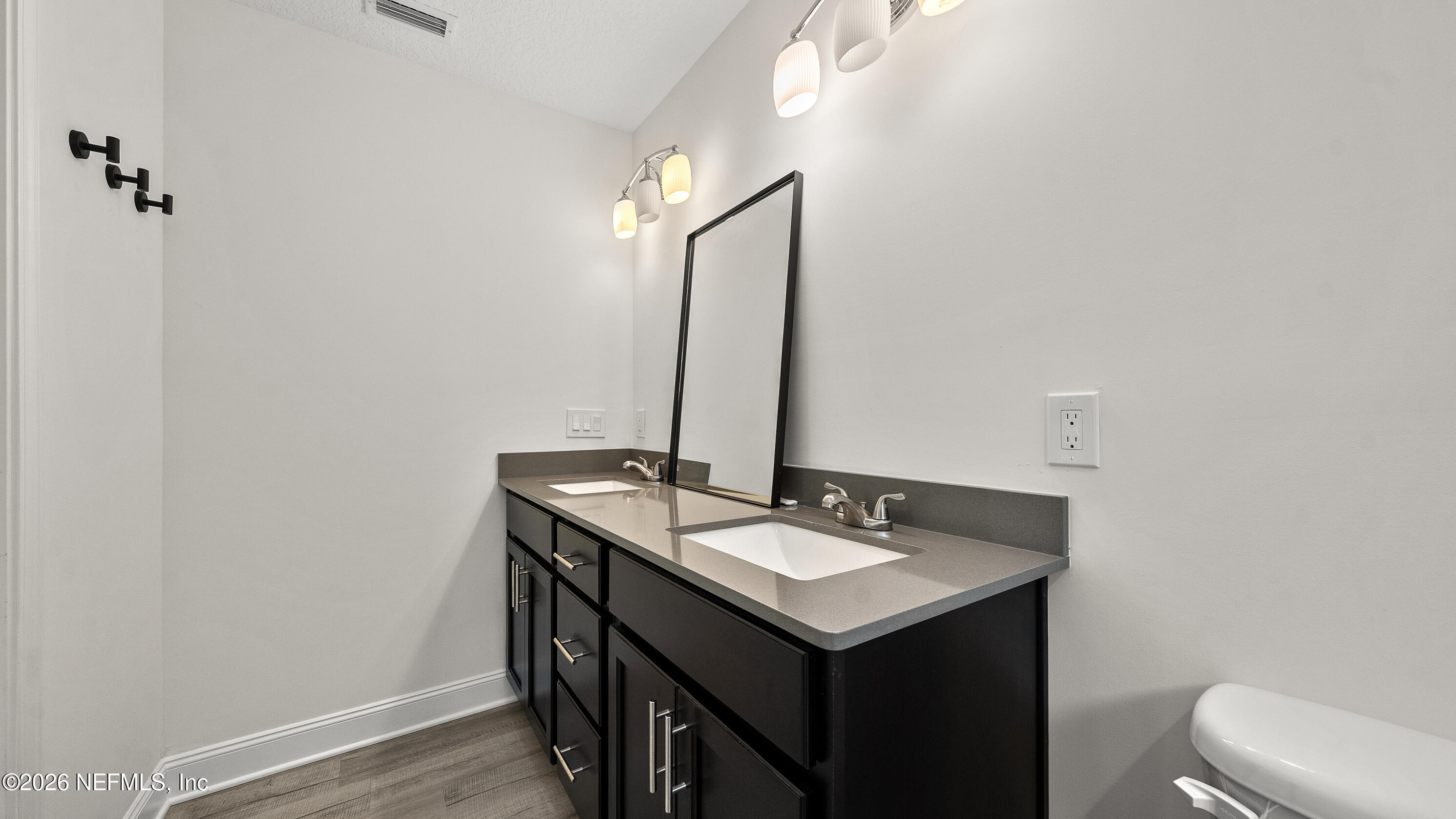 80 Seaside Capers Road St. Augustine, FL 32084 - Photo 28 of 44 a bathroom with a sink and a mirror