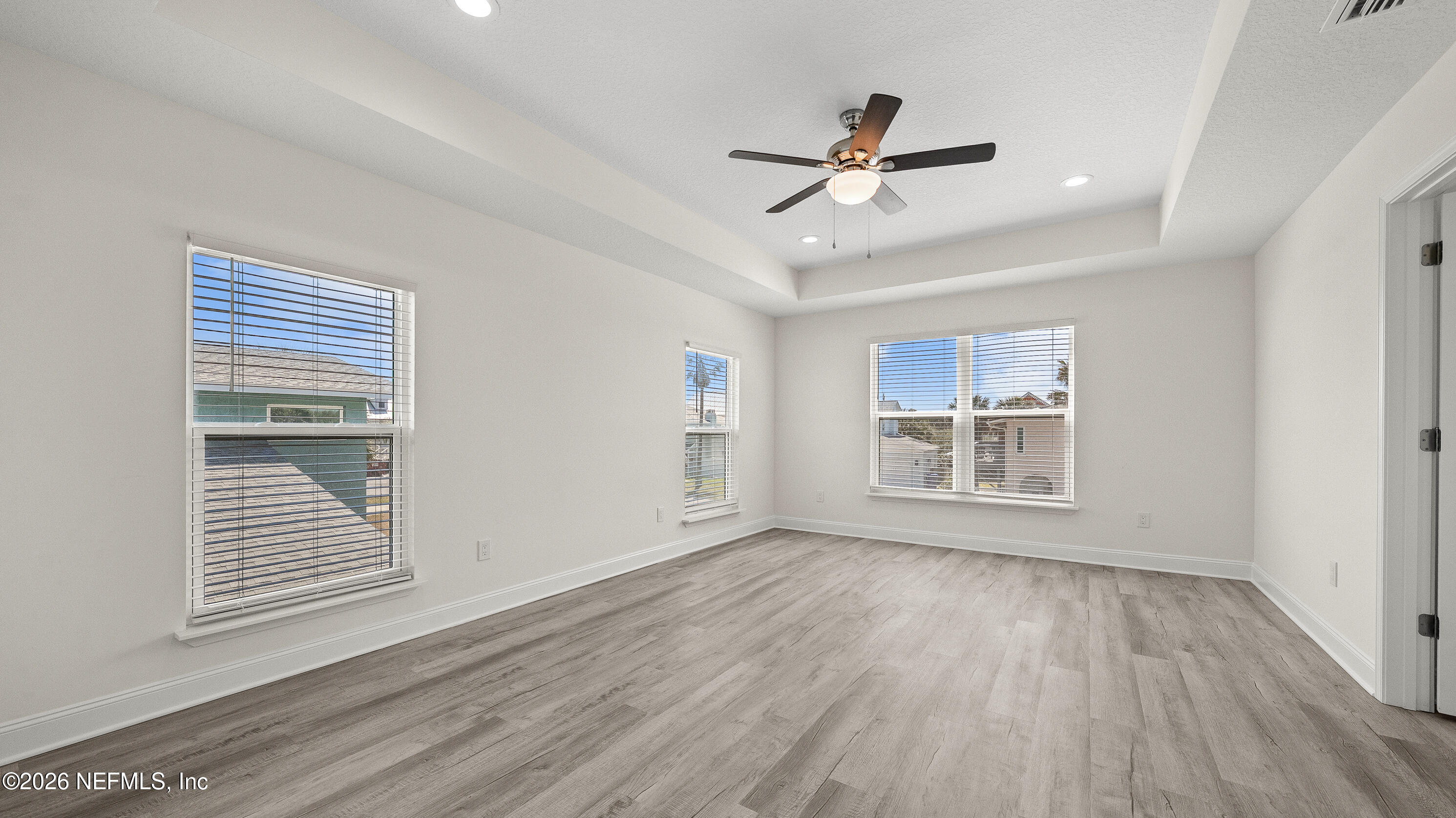 80 Seaside Capers Road St. Augustine, FL 32084 - Photo 29 of 44 a view of an empty room with wooden floor and a window