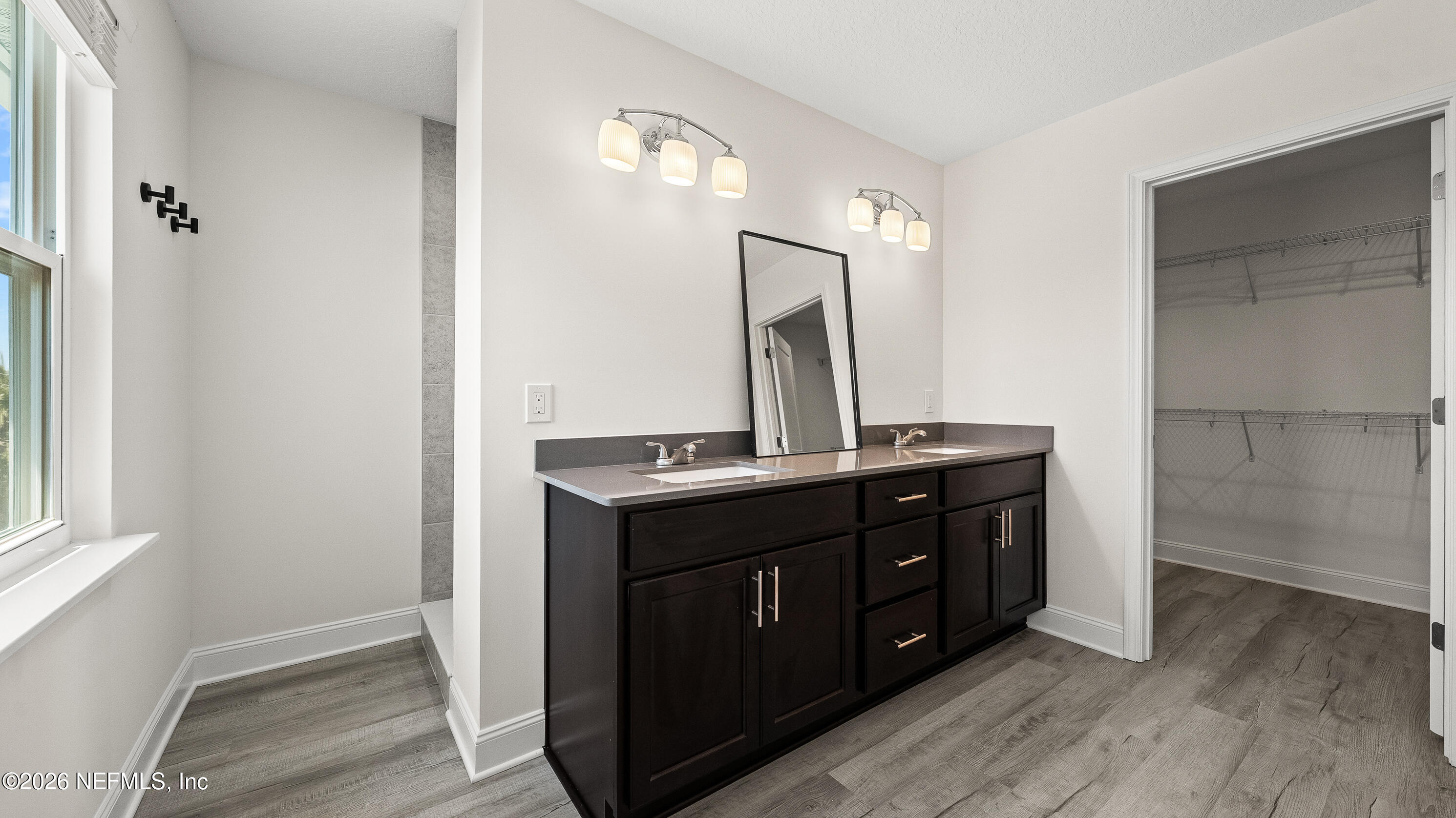 80 Seaside Capers Road St. Augustine, FL 32084 - Photo 32 of 44 a bathroom with a double vanity sink and mirror
