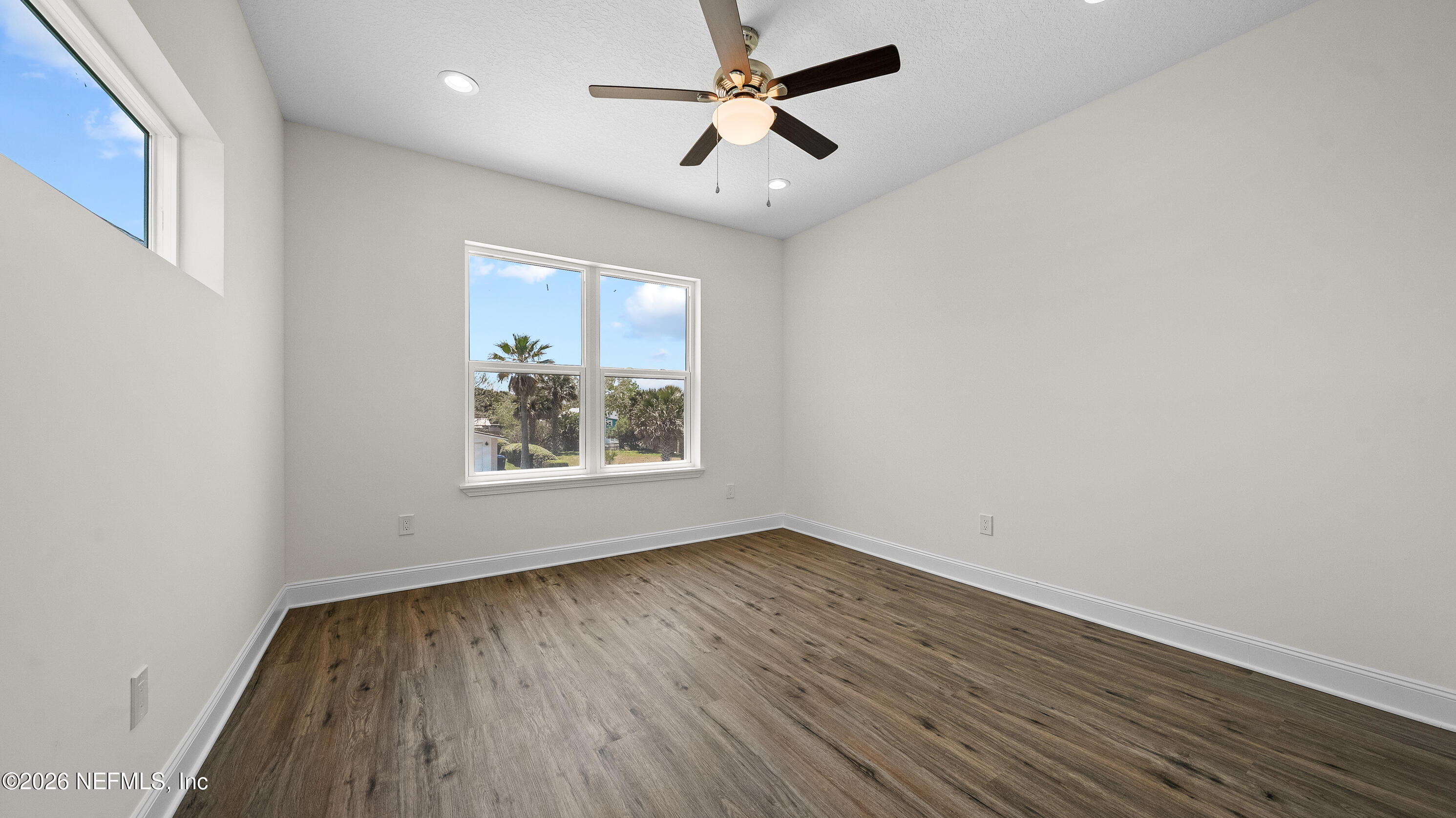 80 Seaside Capers Road St. Augustine, FL 32084 - Photo 39 of 44 wooden floor in an empty room with a window