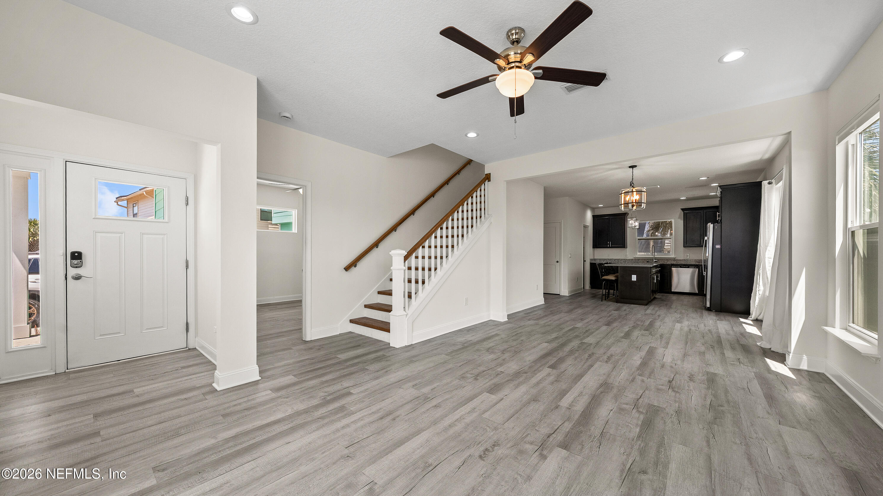 80 Seaside Capers Road St. Augustine, FL 32084 - Photo 5 of 44 wooden floor in an empty room with a kitchen