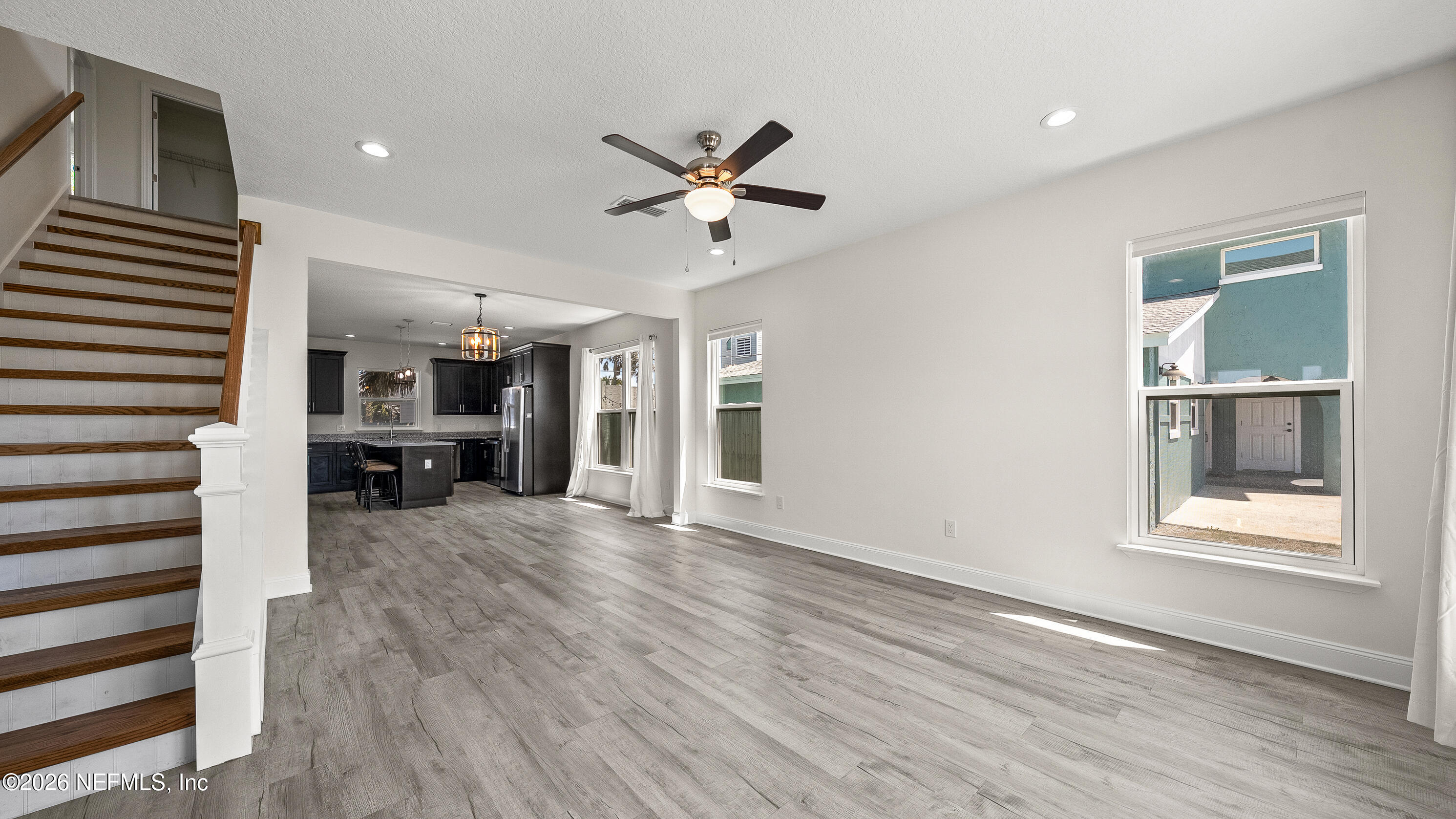 80 Seaside Capers Road St. Augustine, FL 32084 - Photo 6 of 44 a view of a livingroom with a hardwood floor and a ceiling fan