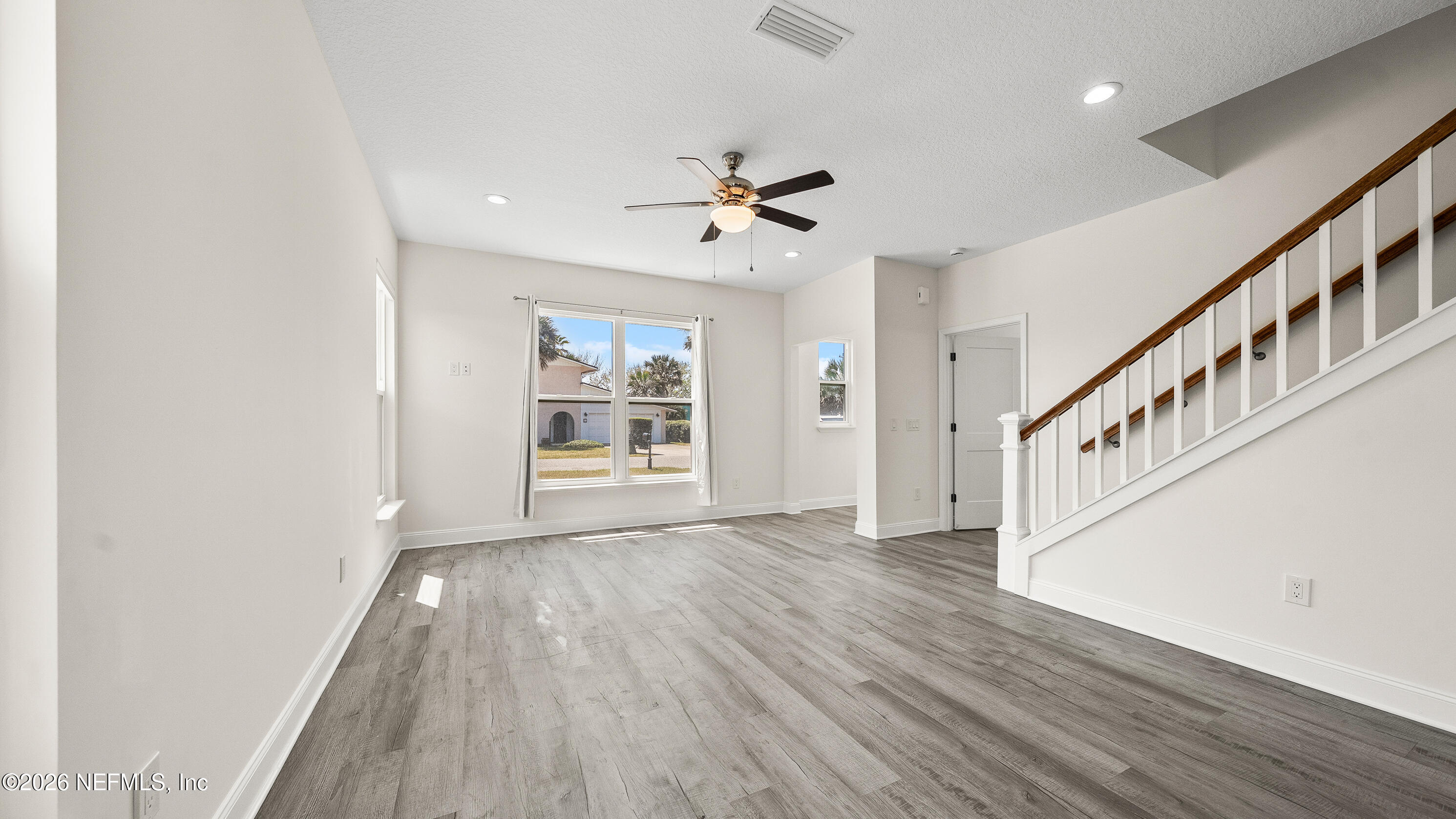 80 Seaside Capers Road St. Augustine, FL 32084 - Photo 8 of 44 wooden floor in an empty room with a window