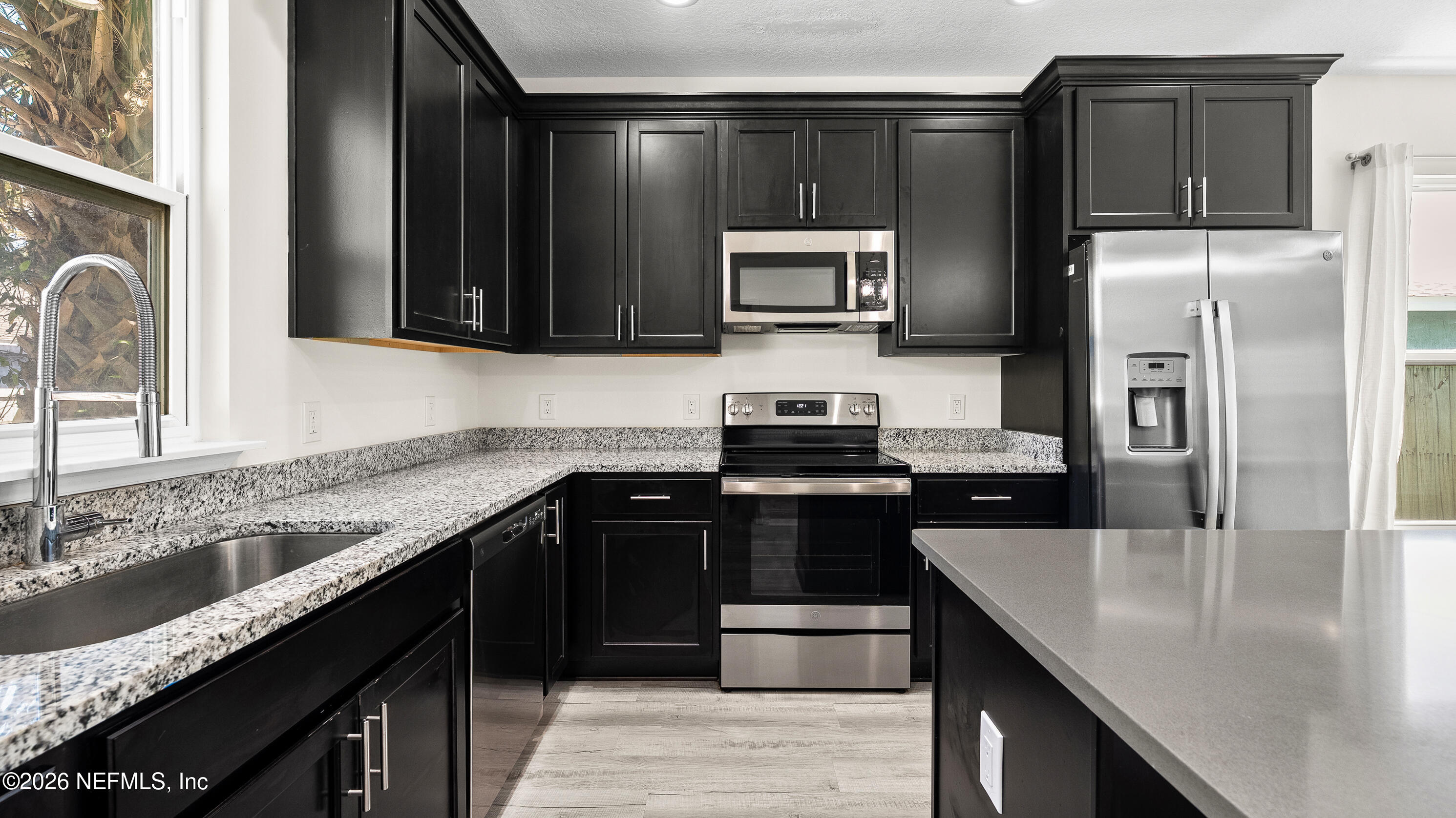 80 Seaside Capers Road St. Augustine, FL 32084 - Photo 10 of 44 a kitchen with a sink and stainless steel appliances