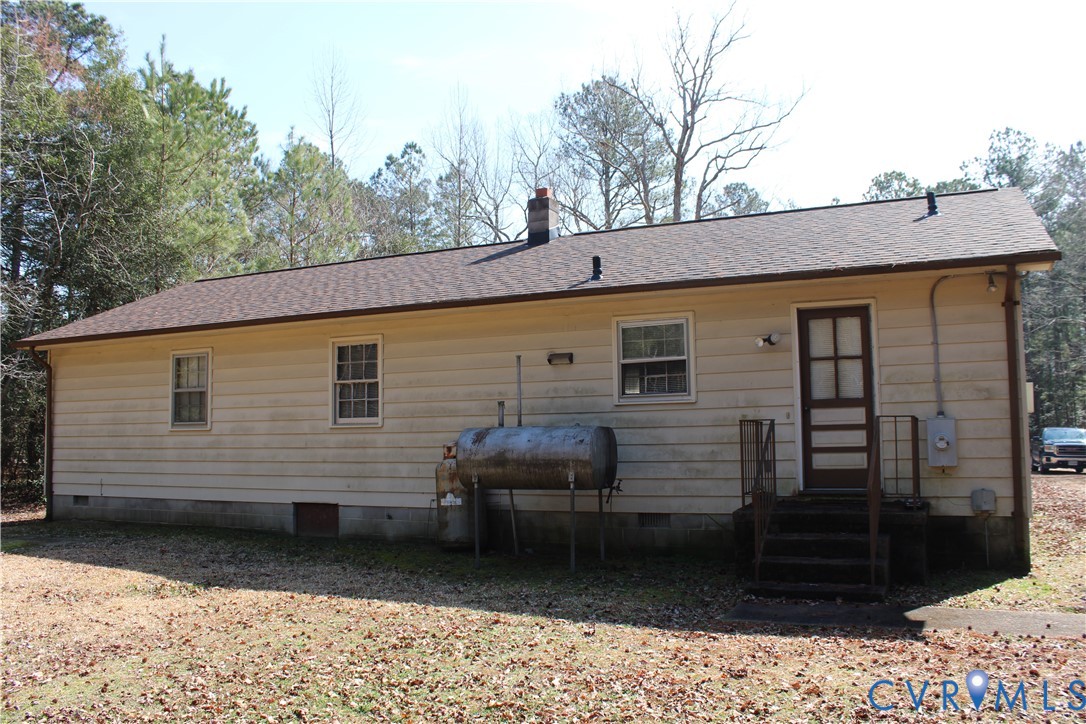 7421 Adkins Road Charles City, VA 23030 - Photo 13 of 14 a view of a house with a backyard