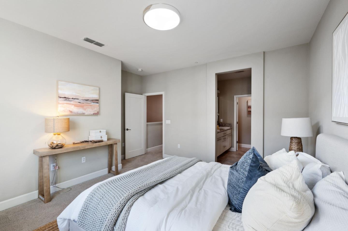 5977 Larkstone Loop San Jose, CA 95123 - Photo 29 of 63 a bedroom with a bed and a table