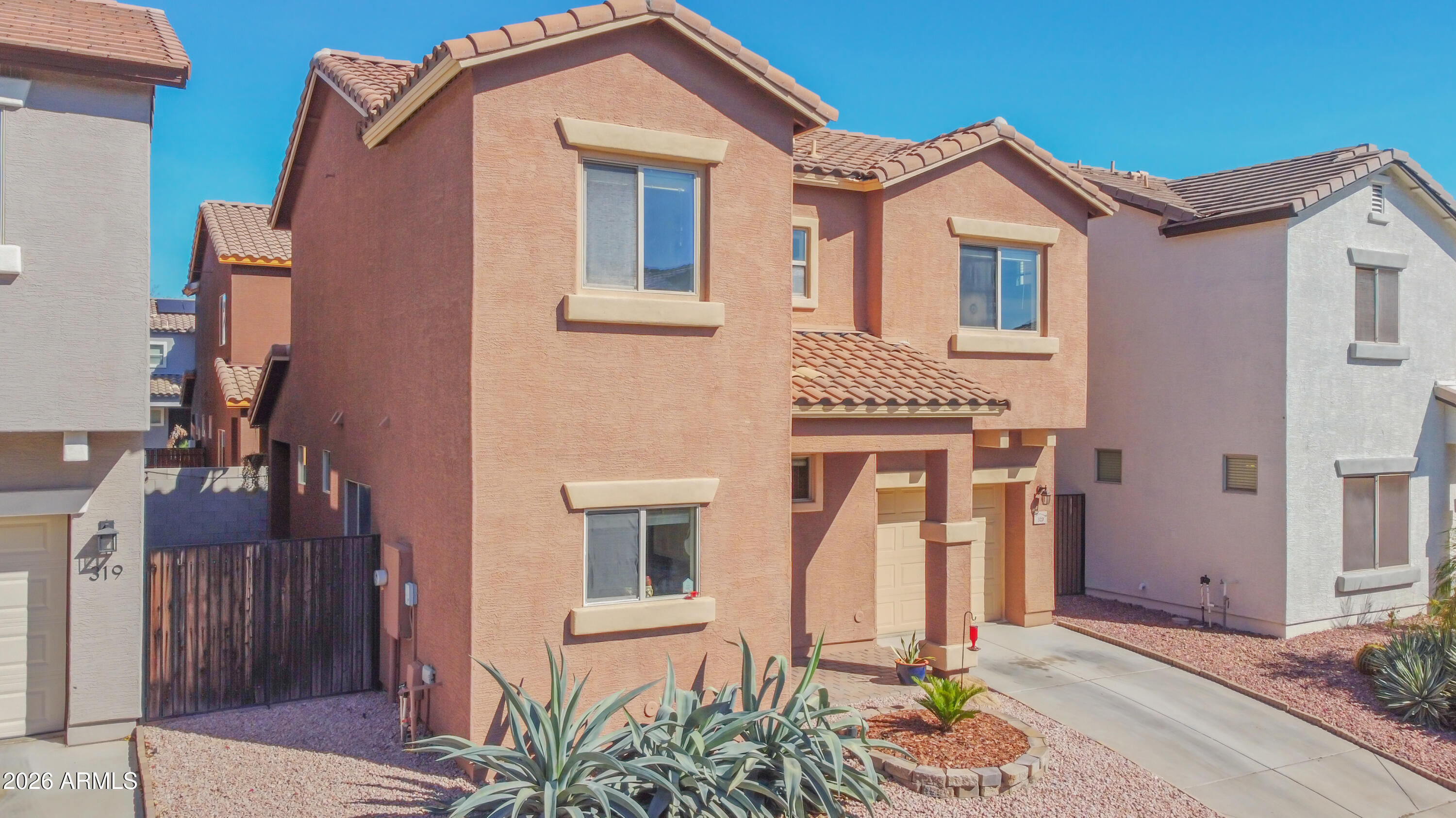 323 South Travis Mesa, AZ 85208 - Photo 2 of 30 a front view of a house with a garden