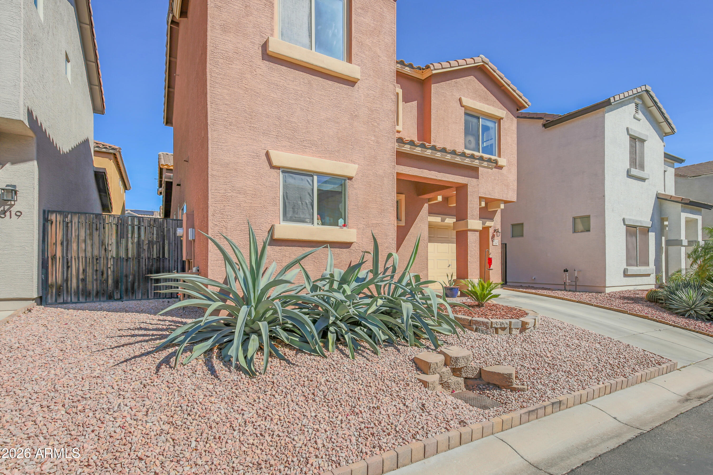 323 South Travis Mesa, AZ 85208 - Photo 25 of 30 a front view of a house with garden