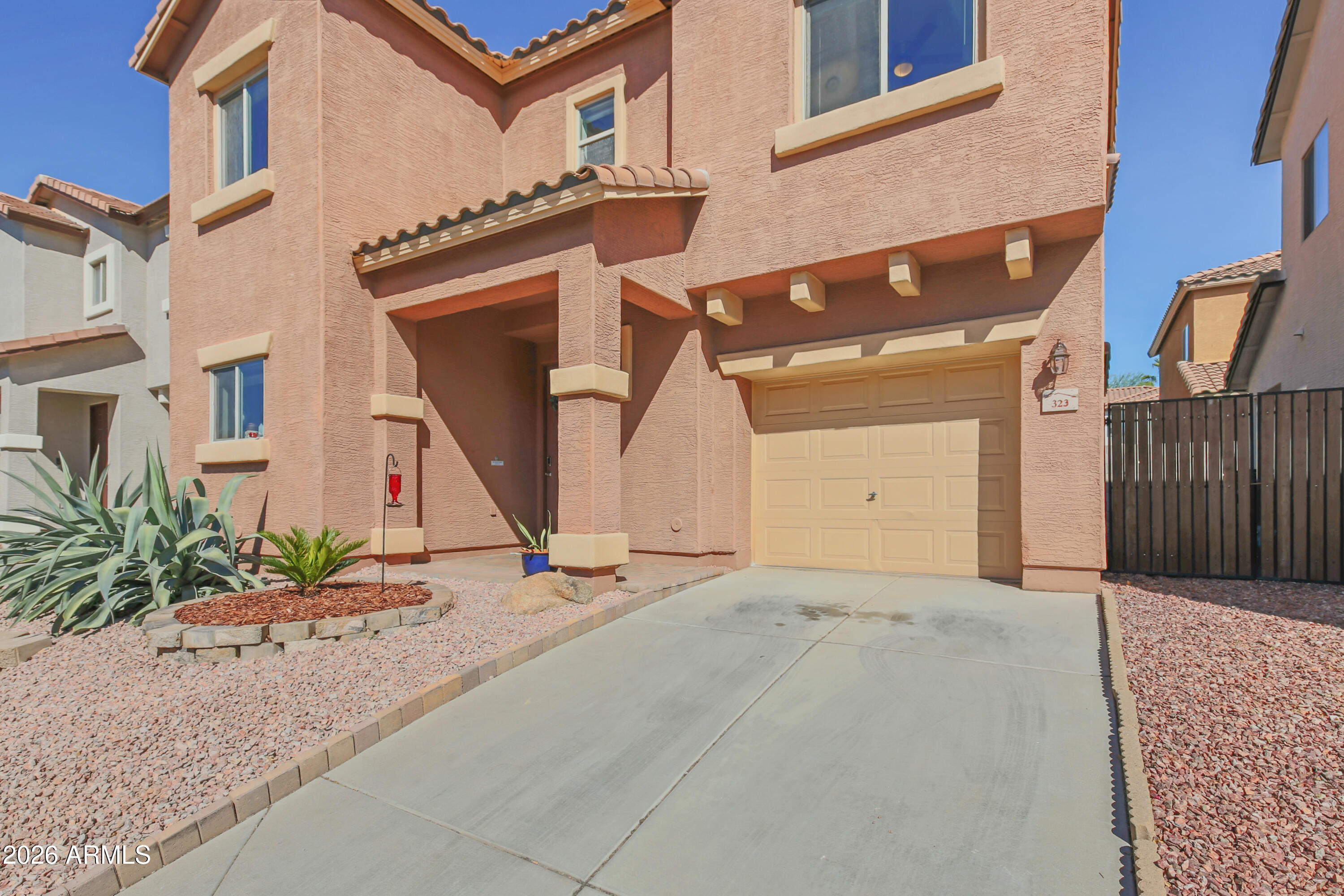 323 South Travis Mesa, AZ 85208 - Photo 27 of 30 a front view of a house with a yard and garage