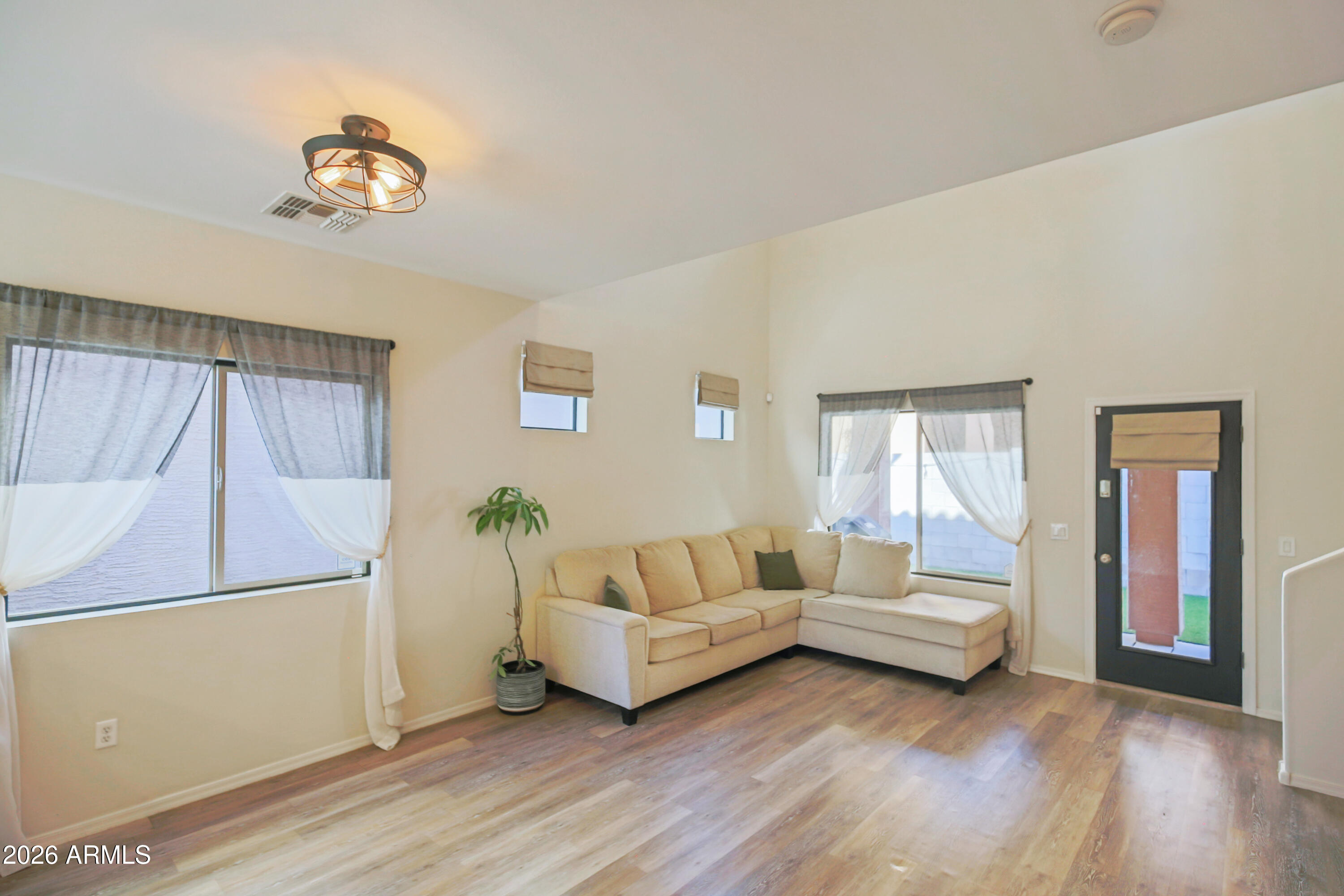 323 South Travis Mesa, AZ 85208 - Photo 5 of 30 a living room with furniture and a large window